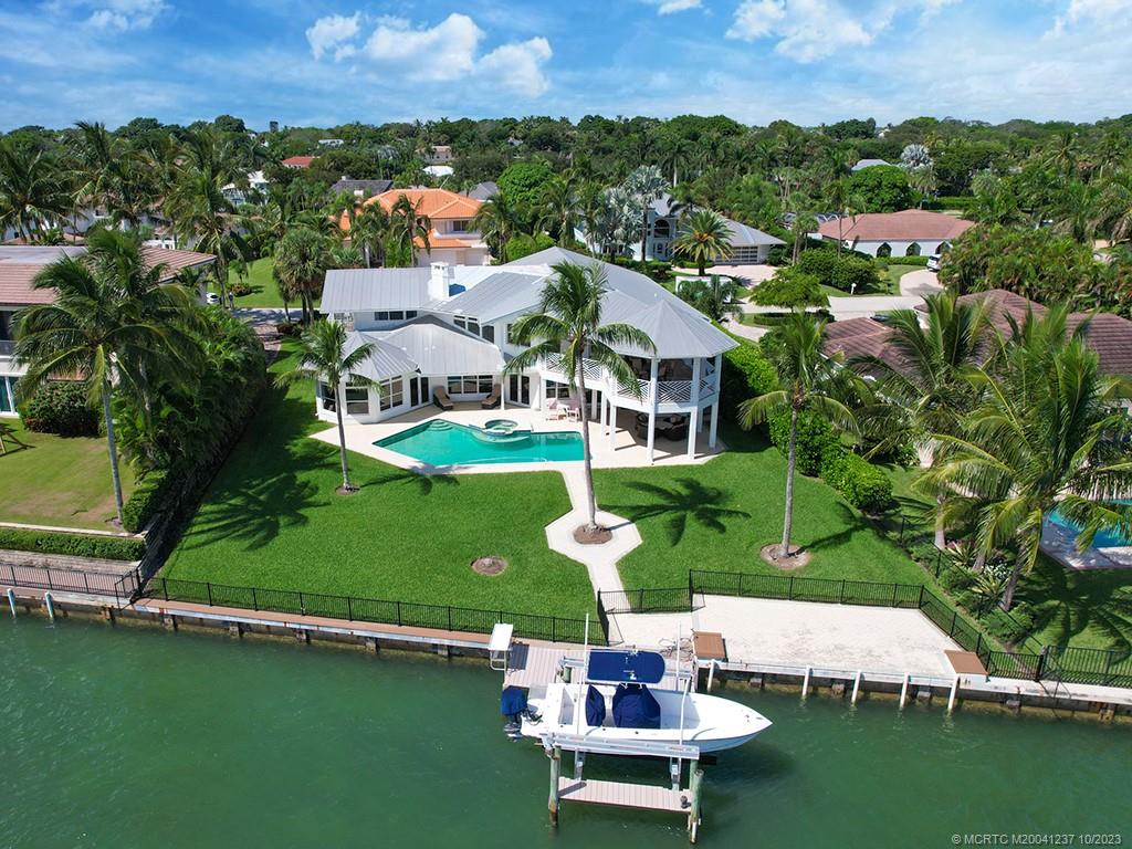 10 Island Road Stuart, FL 34996 - Photo 5 of 60 an aerial view of a house with a garden and lake view