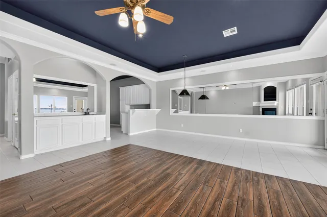 a living room with a fireplace and a floor to ceiling window