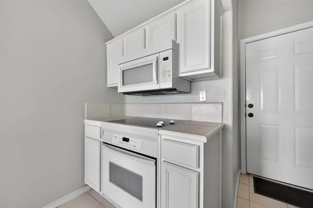 a stove top oven sitting inside of a kitchen