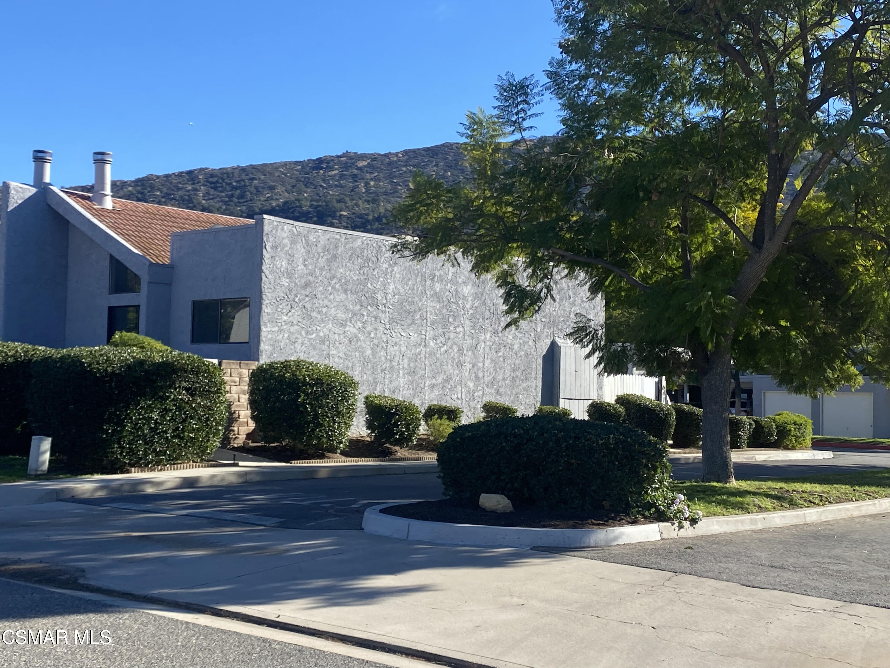 6416 Katherine Road, Unit D Simi Valley, CA 93063 - Photo 1 of 12 a front view of a house with a yard