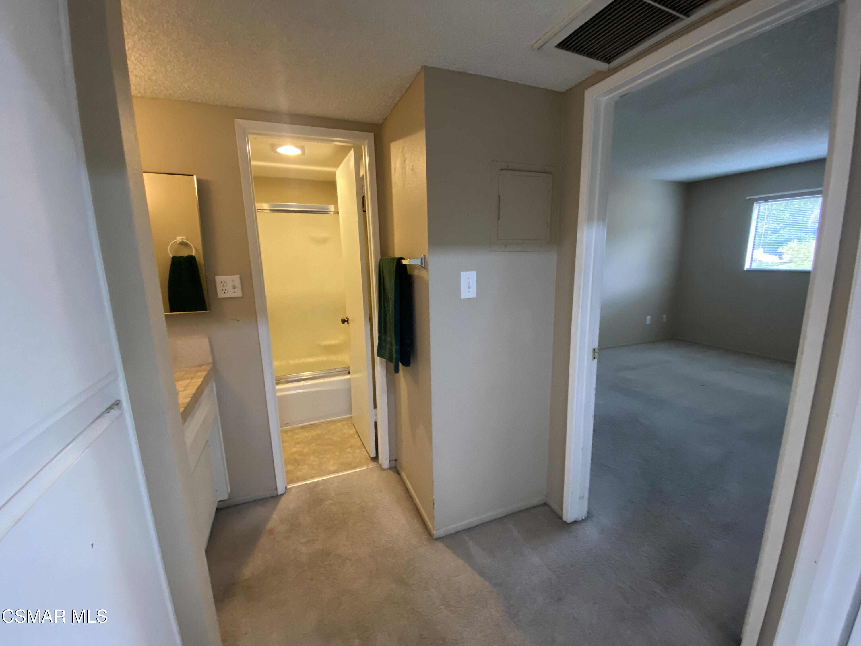 6416 Katherine Road, Unit D Simi Valley, CA 93063 - Photo 11 of 12 a view of a hallway with wooden floor and a livingroom