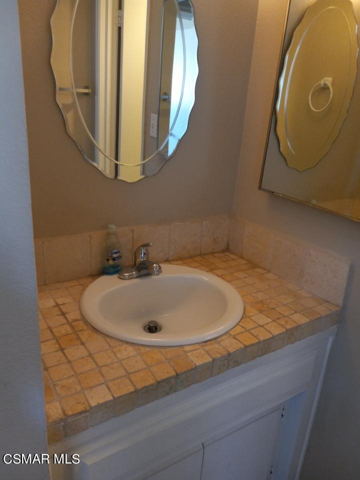 6416 Katherine Road, Unit D Simi Valley, CA 93063 - Photo 7 of 12 a bathroom with a sink and mirror