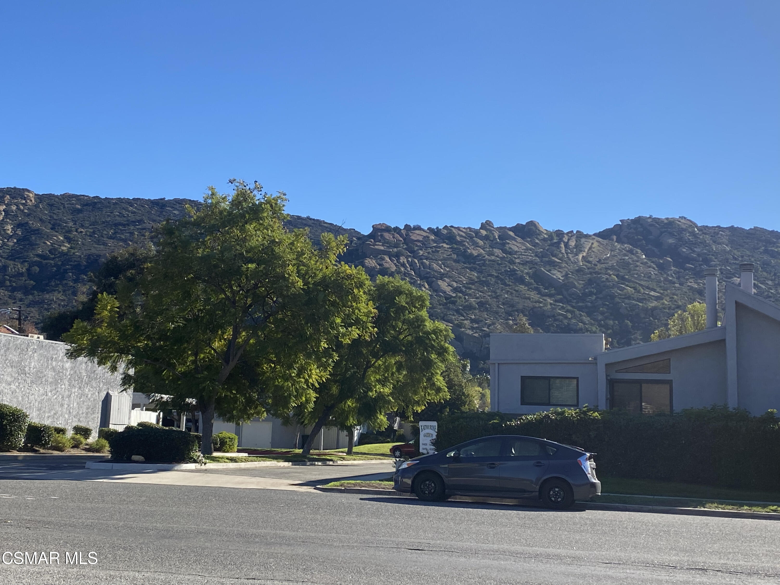 6416 Katherine Road, Unit D Simi Valley, CA 93063 - Photo 10 of 12 a street view with large trees