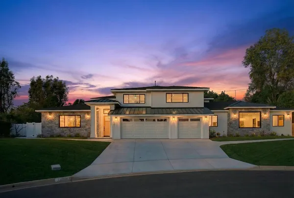 a front view of a house with a yard and a garage