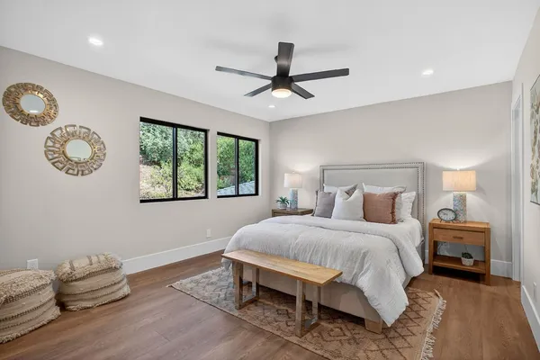 a bedroom with a large bed and a mirror