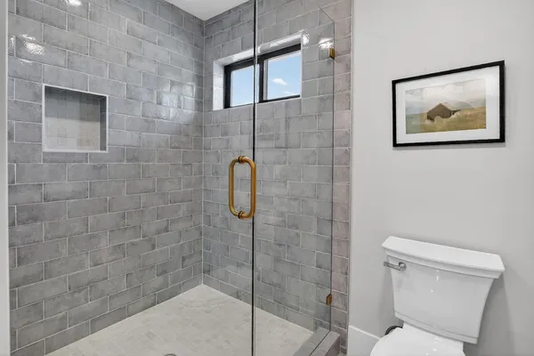 a living room with a bed and a painting on the wall