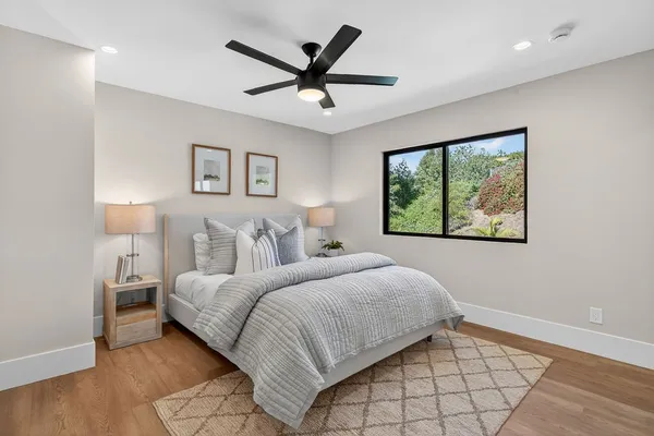 a spacious bedroom with a large bed and a chandelier