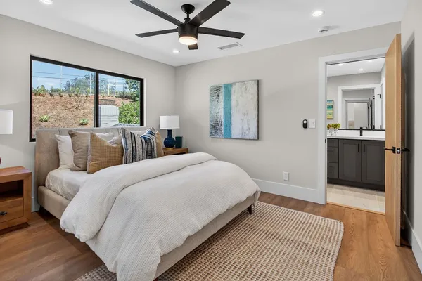 a bathroom with a granite countertop sink a mirror and a bathtub