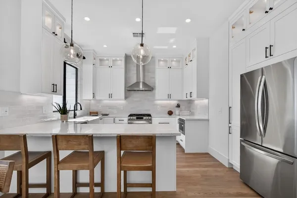 a kitchen with a stove a sink and a refrigerator