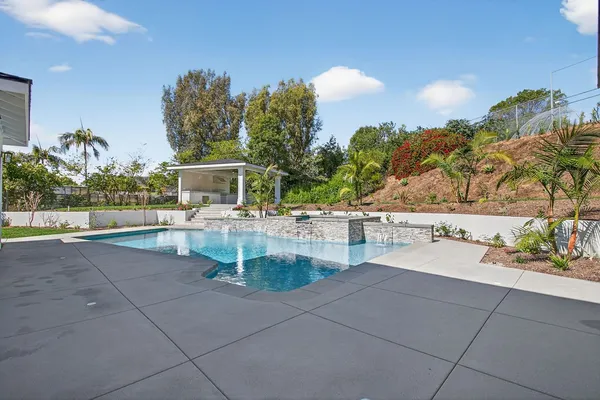 a view of a swimming pool with a patio