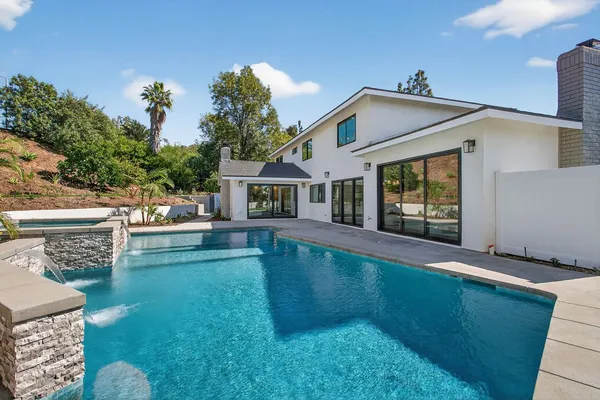 a view of a kitchen with a sink and windows