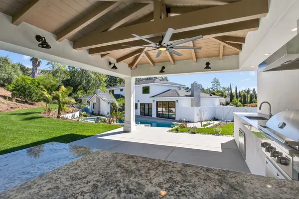swimming pool view with a seating space and garden view