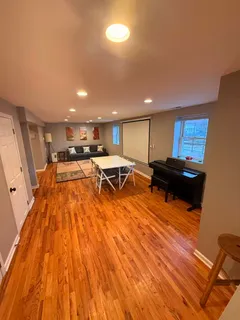 a living room with a couch and wooden floor