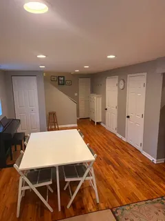 a view of a room with furniture and wooden floor