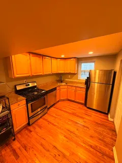 a view of a kitchen with wooden floor