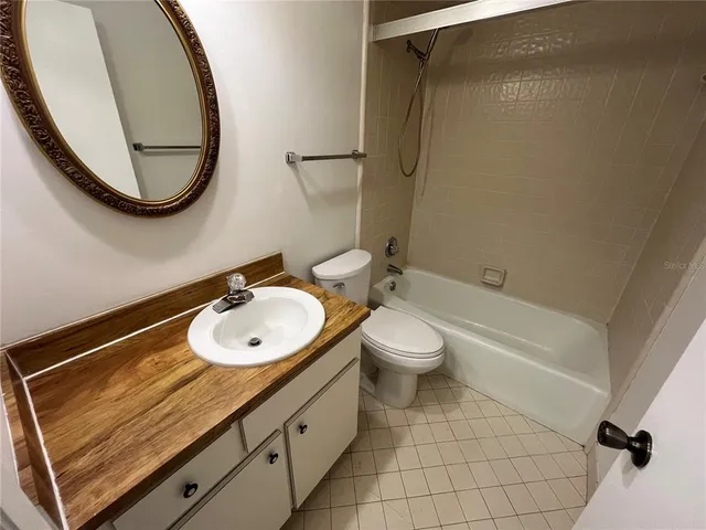 a bathroom with a sink mirror vanity and toilet