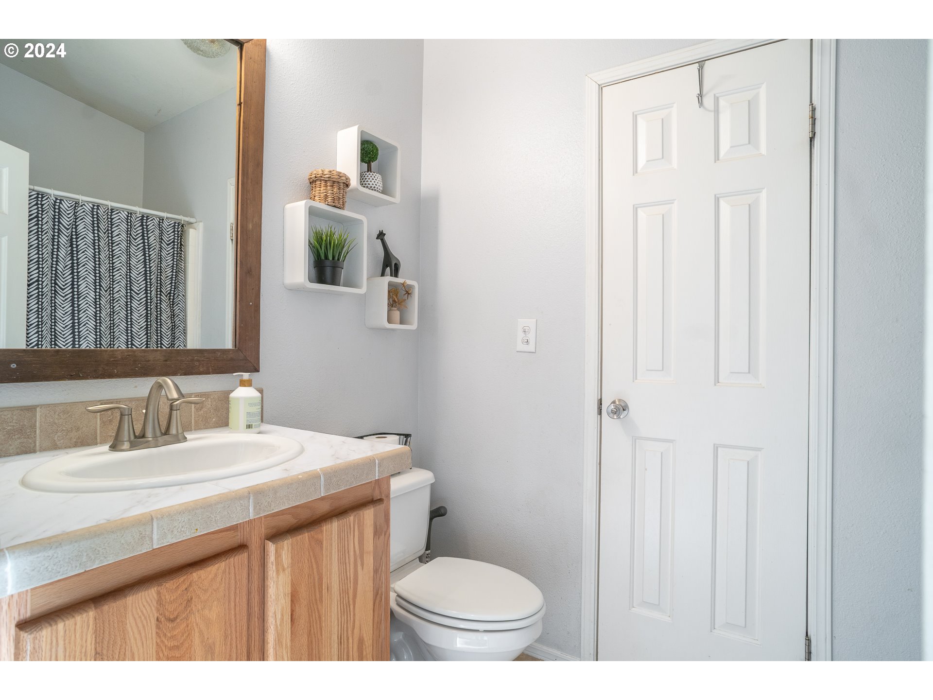 22233 Northeast Basket Flat Road Battle Ground, WA 98604 - Photo 22 of 46 a bathroom with a sink a toilet and mirror