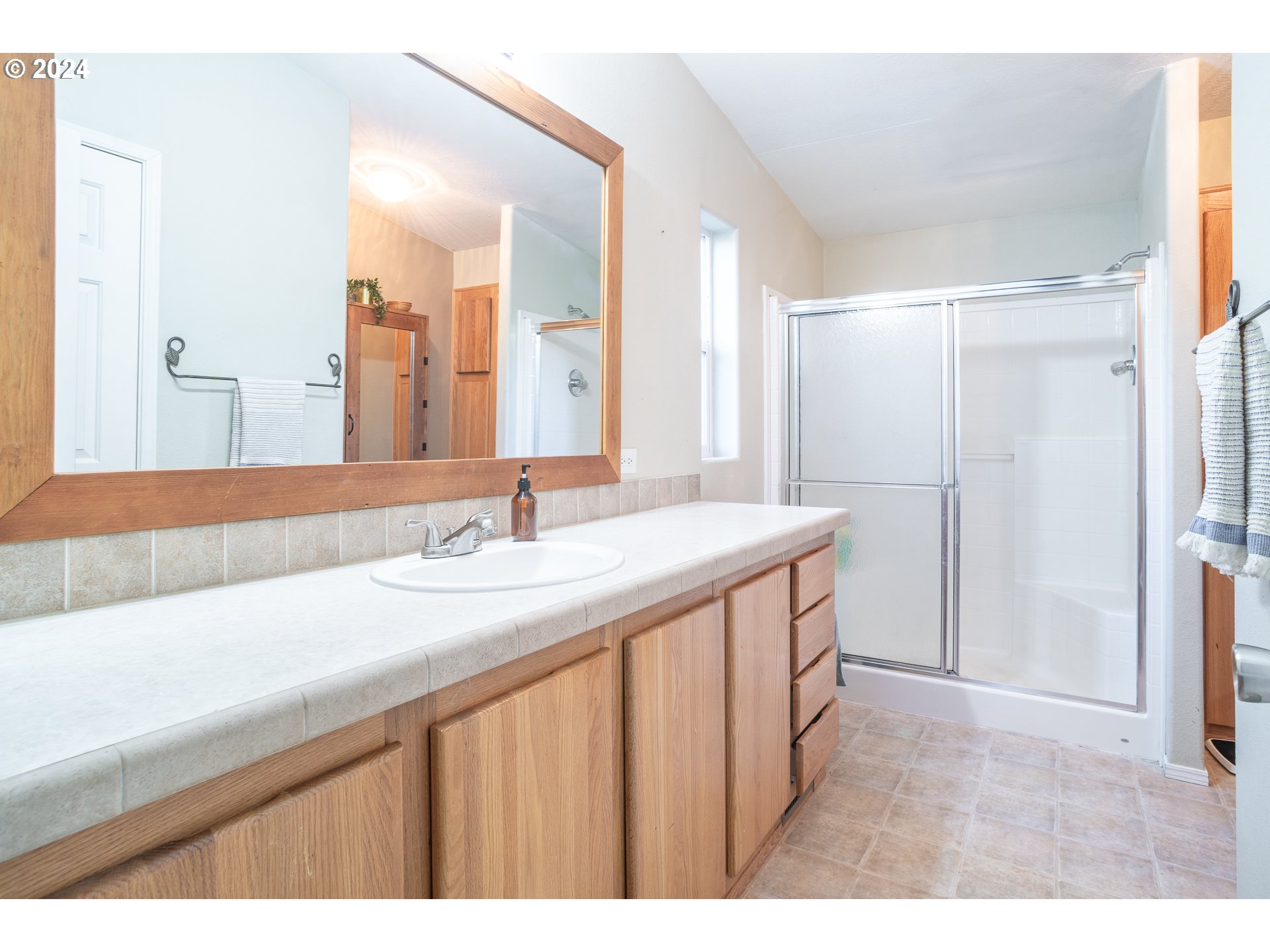 22233 Northeast Basket Flat Road Battle Ground, WA 98604 - Photo 31 of 46 a bathroom with a double vanity sink and mirror