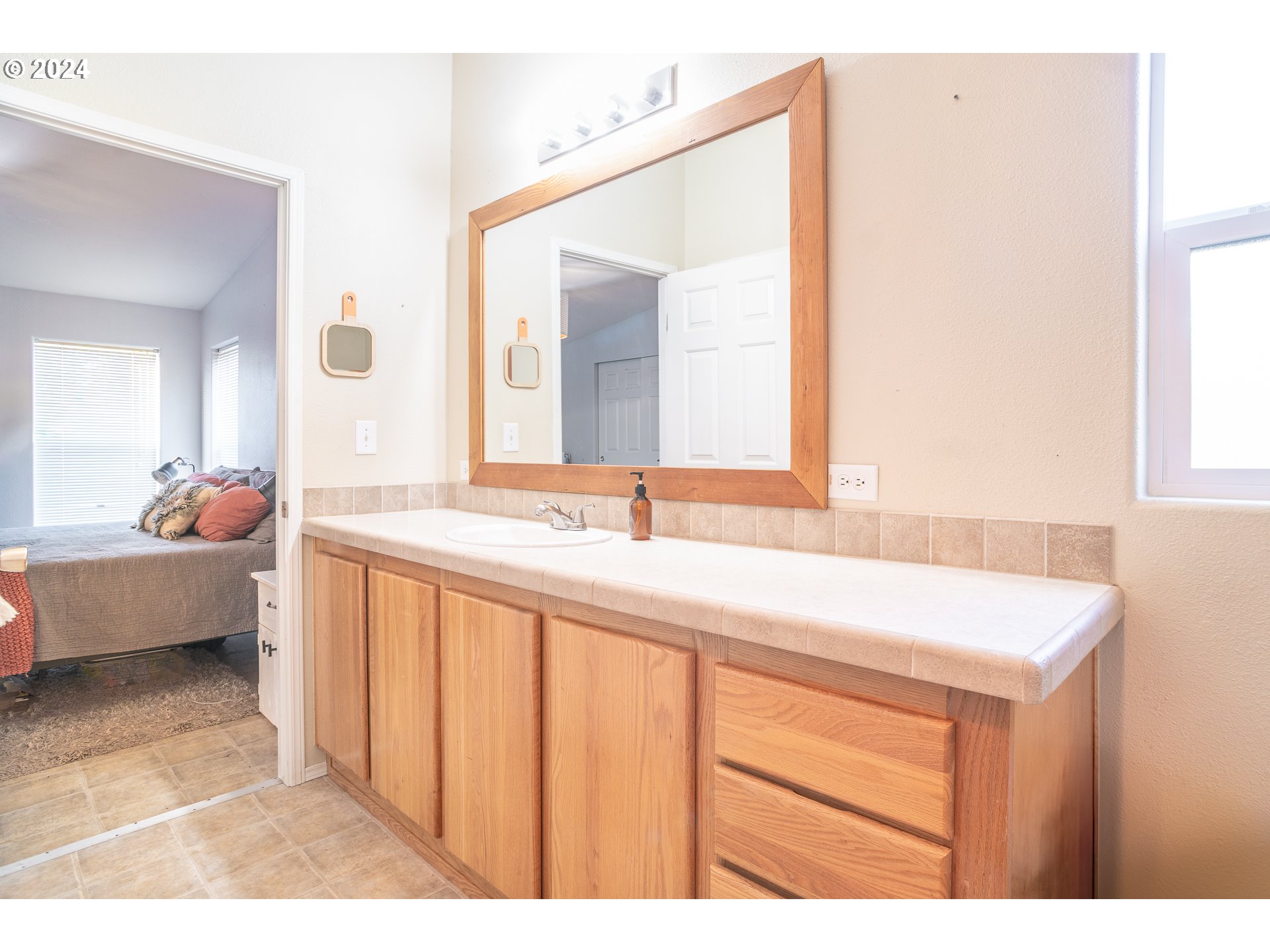 22233 Northeast Basket Flat Road Battle Ground, WA 98604 - Photo 32 of 46 a en suite bathroom with a granite countertop sink and a mirror