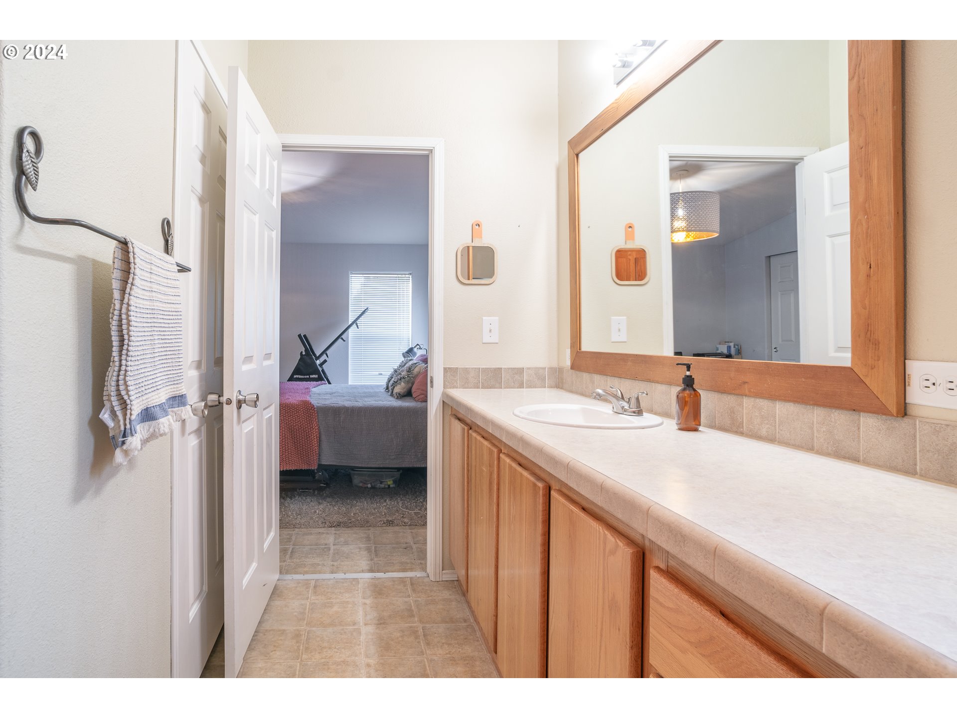 22233 Northeast Basket Flat Road Battle Ground, WA 98604 - Photo 34 of 46 a en suite bathroom with a double vanity sink a mirror and a bathtub
