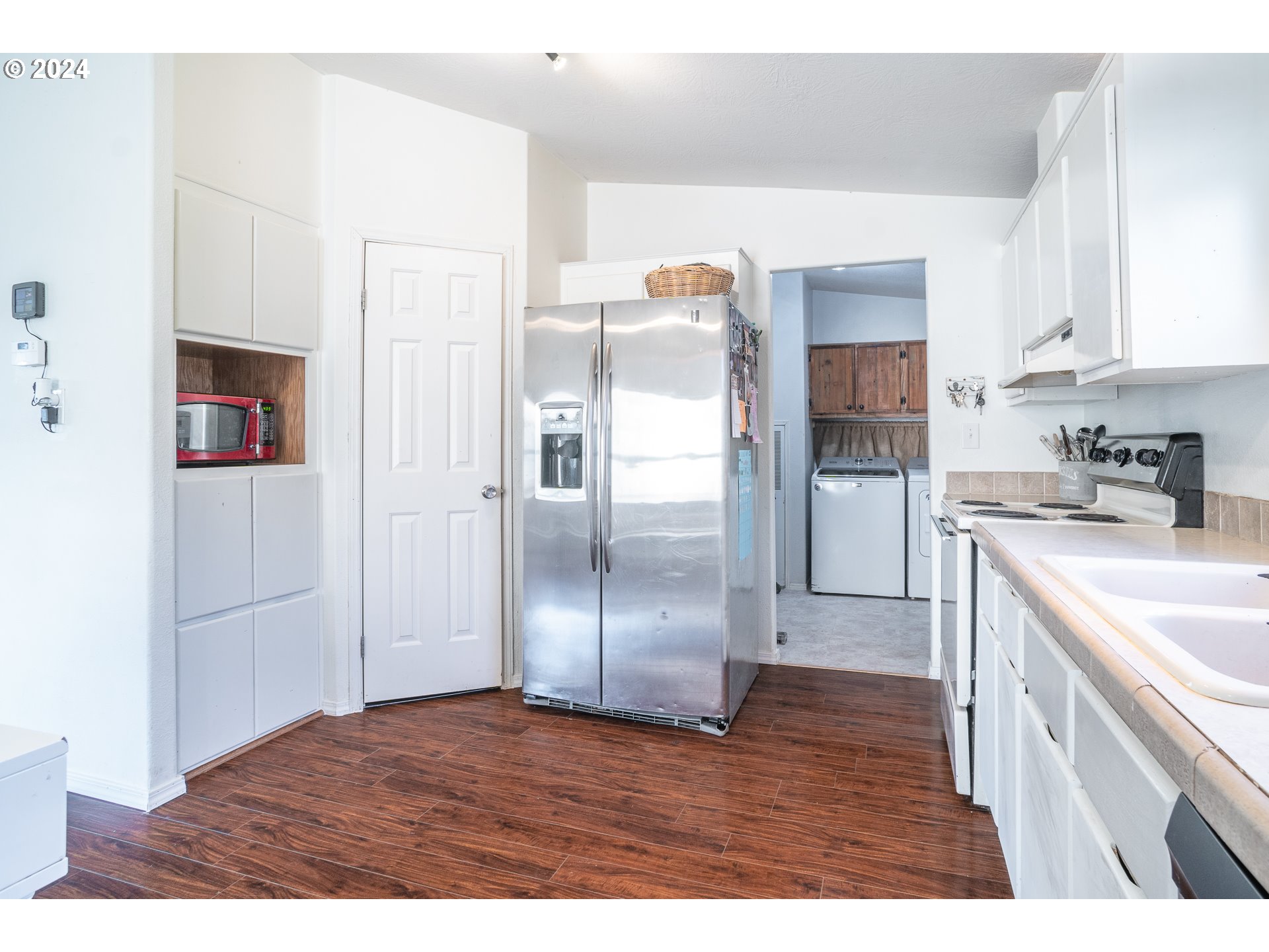 22233 Northeast Basket Flat Road Battle Ground, WA 98604 - Photo 36 of 46 a kitchen with stainless steel appliances granite countertop a refrigerator a sink and white cabinets