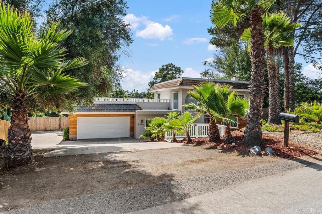 a view of a house with a tree and garden