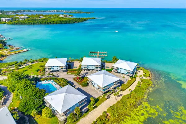 an aerial view of a house with a ocean view