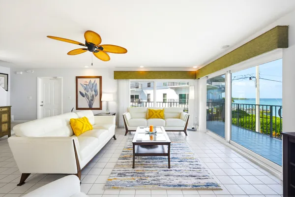 a living room with furniture and floor to ceiling windows