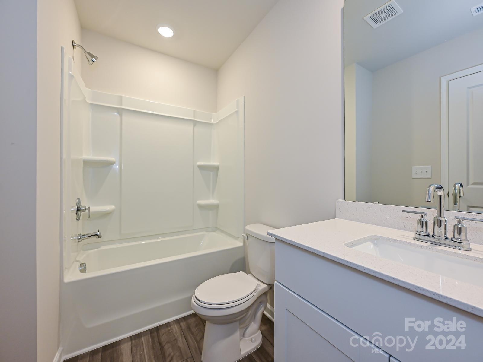 3840 Backwater Street Concord, NC 28027 - Photo 13 of 23 a bathroom with a sink toilet vanity and shower