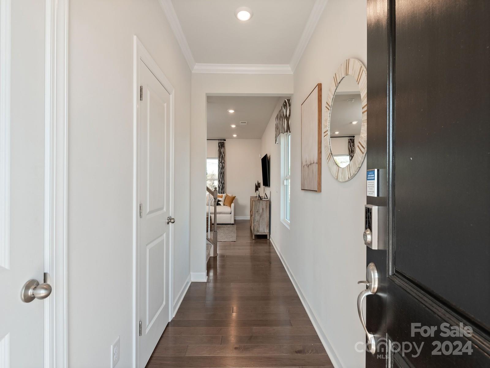 3840 Backwater Street Concord, NC 28027 - Photo 21 of 23 a view of a hallway with a dining table & a mirror