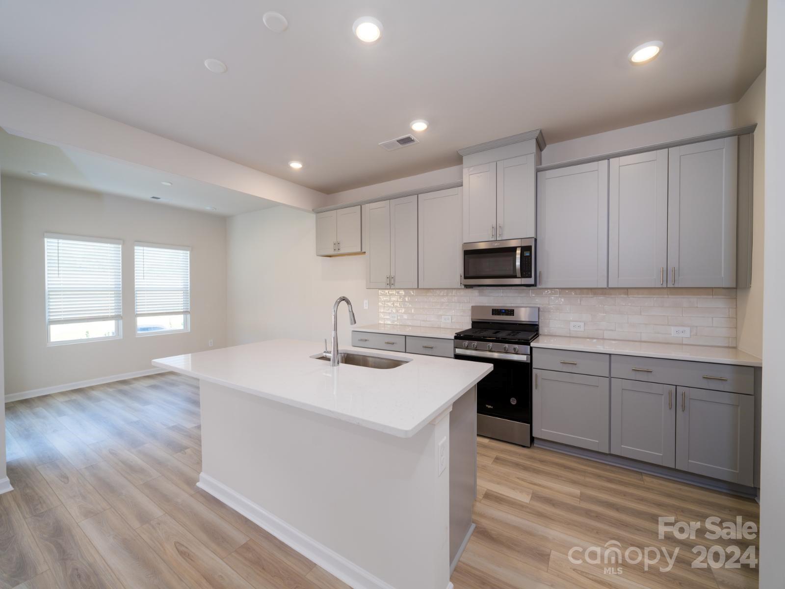 3840 Backwater Street Concord, NC 28027 - Photo 5 of 23 a kitchen with sink cabinets and stainless steel appliances