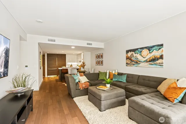 a living room with furniture a couch and a potted plant