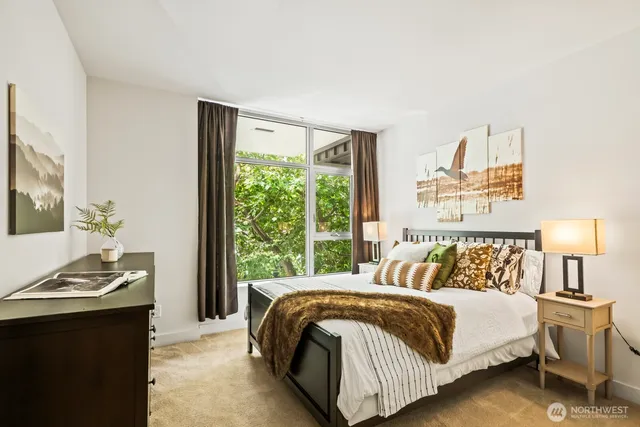 a bedroom with a bed and a refrigerator