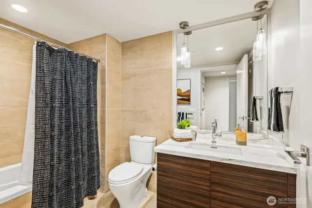 a bathroom with a shower curtain and a window