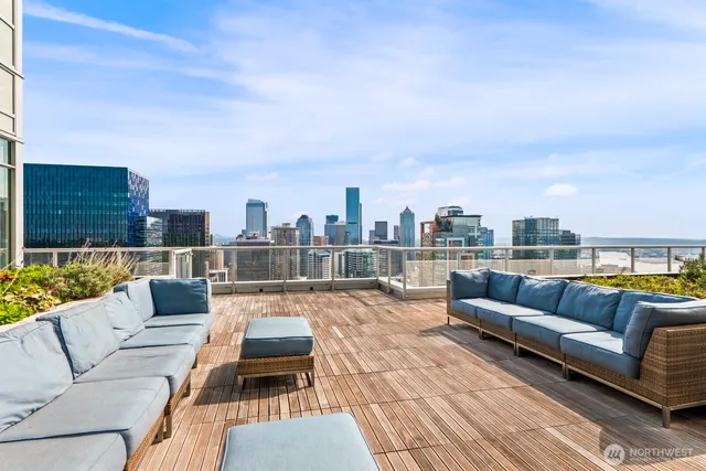 a living room with furniture and floor to ceiling windows