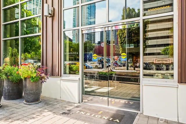 a living room with furniture and large windows