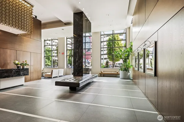 a lobby with furniture and a flat screen tv