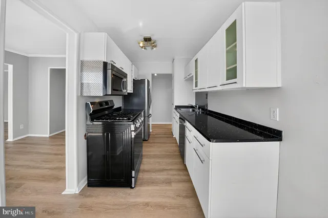a kitchen with stainless steel appliances a sink stove and refrigerator