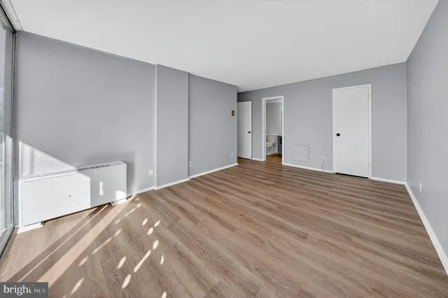 a view of a room with wooden floor