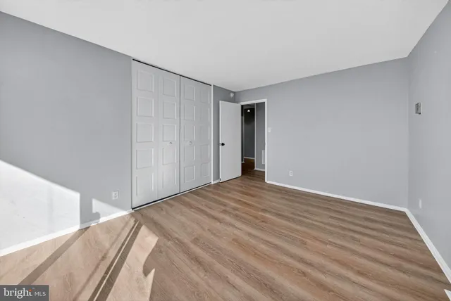 a view of a room with wooden floor