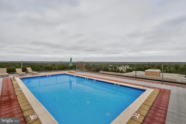 a view of a terrace with lawn chairs