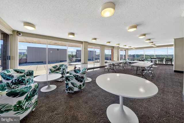 a very nice looking room with kitchen island furniture and a chandelier