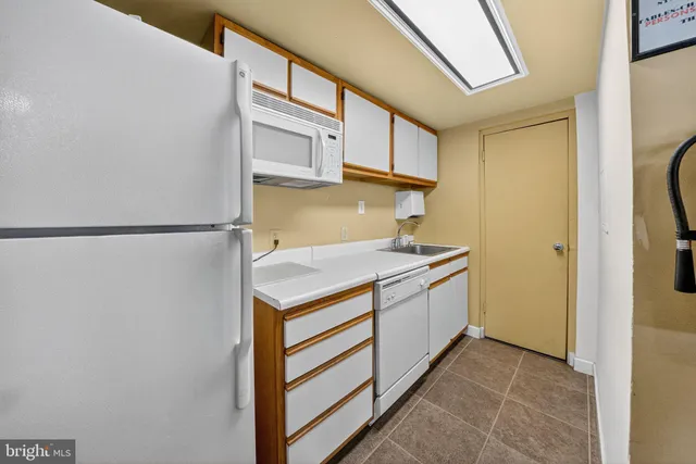 a kitchen with stainless steel appliances a stove a sink and a refrigerator