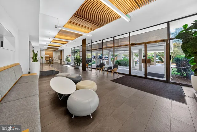 a living room with couches and a large window with outer view