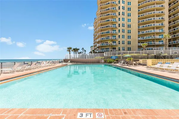 a view of swimming pool with outdoor seating and yard