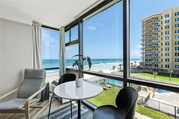 a view of a dining room with furniture and window