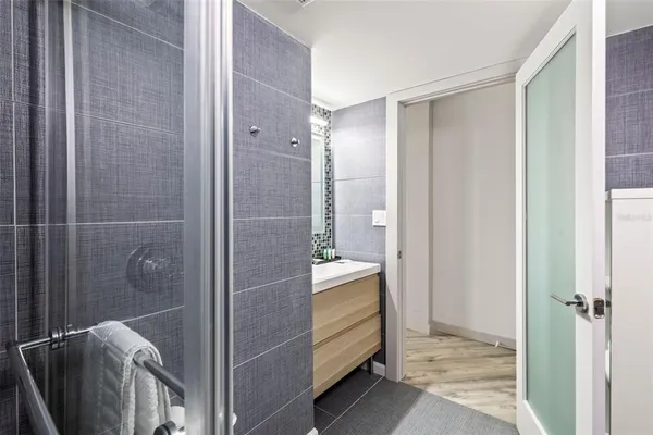 a bathroom with a shower and a sink