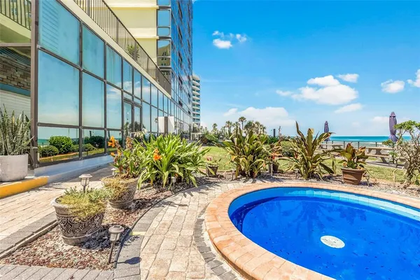 a view of a swimming pool with a lounge chair