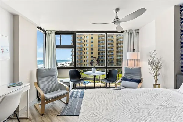 a living room with furniture and large windows