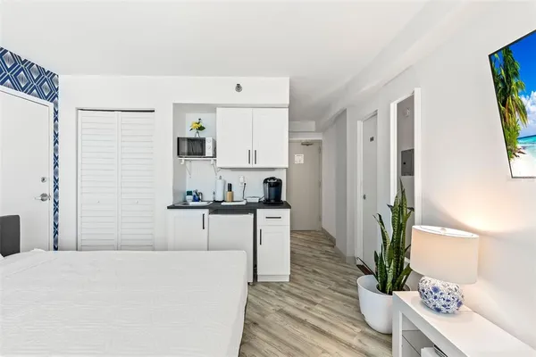 a kitchen with kitchen island a counter top space a sink and cabinets